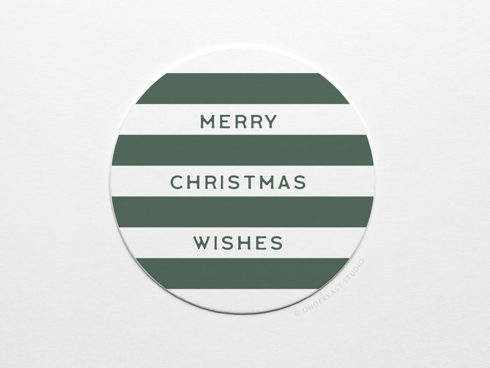 The Merry Christmas Wishes Coaster Set by Onderkast Studio features round pulp board coasters with white and dark green stripes, MERRY CHRISTMAS WISHES in all caps, and comes in recyclable packaging for eco-friendly gifting.