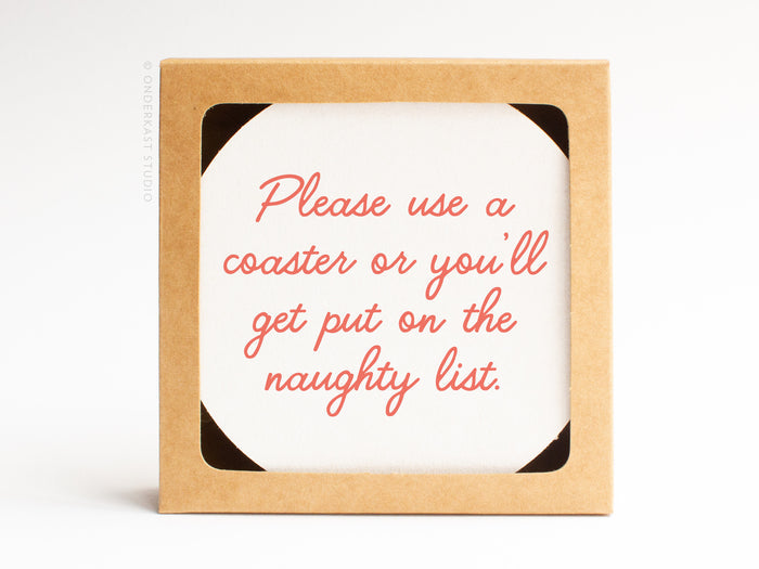 The Naughty List Coaster Set by Onderkast Studio comes in a square brown box and includes a handmade-quality pulp board coaster with red script: Please use a coaster or youll get put on the naughty list.