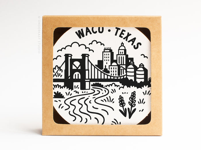 The Waco Texas Skyline Letterpress Coaster Set by Onderkast Studio features black-and-white cityscape illustrations, including a bridge, river, buildings, silos, and plants with WACO • TEXAS at the top, packaged in a cardboard box.